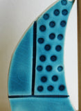 teal dot sail close up