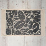 Cotton Tea Towel with Pebbles on the Shore Lino Print