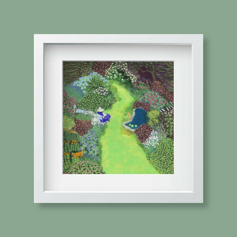 A framed art print depicting a woman enjoying her beautful garden and pond, presented in a white frame