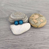 Claire Fernig Spinnaker Glass Mini Teal 925 Silver stud earrings on beach pebbles