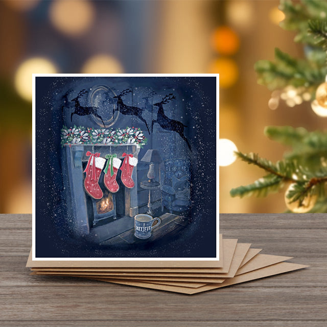 A set of 6 Christmas note cards with kraft envelopes by Alli Conner with stockings and a fireplace design