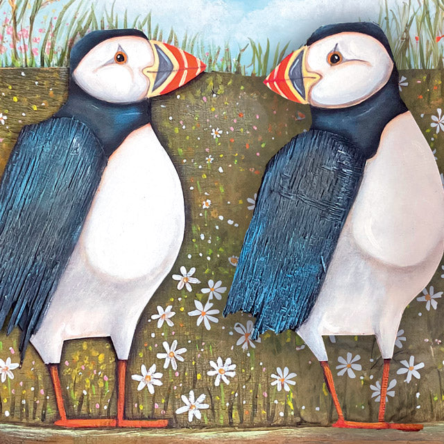 A whimsical painting by painter Claire Brierley of two puffins facing each other.