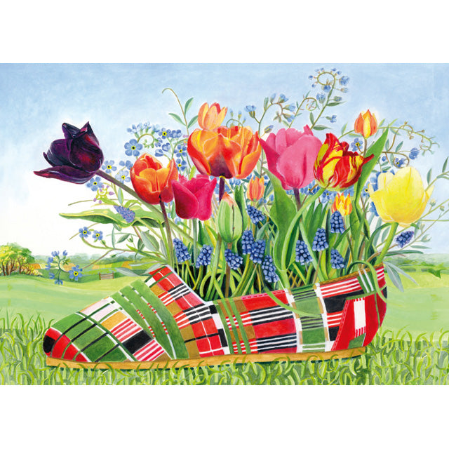 Colorful tulips emerging from a checkered shoe in a garden setting. A fine art greeting card by painter E B Watts