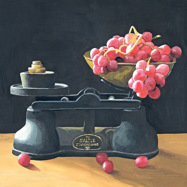 A still-life painting of a vintage black balance scale with a bowl of red grapes on its platform, set against a dark background and light wood surface.