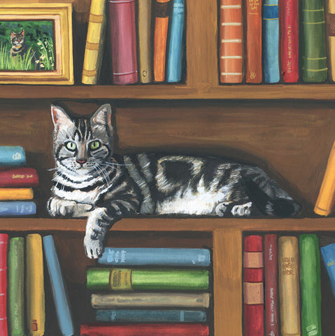 A painted scene of a gray tabby cat lying on a wooden bookshelf surrounded by colorful books. A small framed picture of a cat appears in the upper left corner.