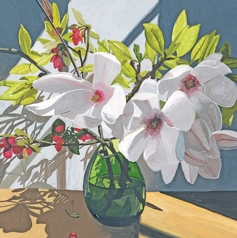A still life painting of white magnolia flowers with pink centers and green leaves in a translucent green glass vase, set on a wooden table against a blue-gray background.