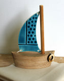 1 sail teal boat close up